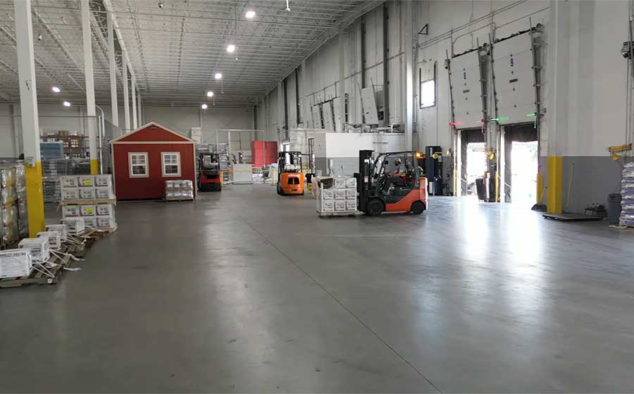 A forklift organizing product inside the DeLo warehouse